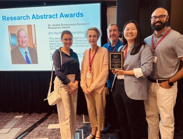 Faculty and students from the Division of Thoracic Surgery standing on stage after winning an award